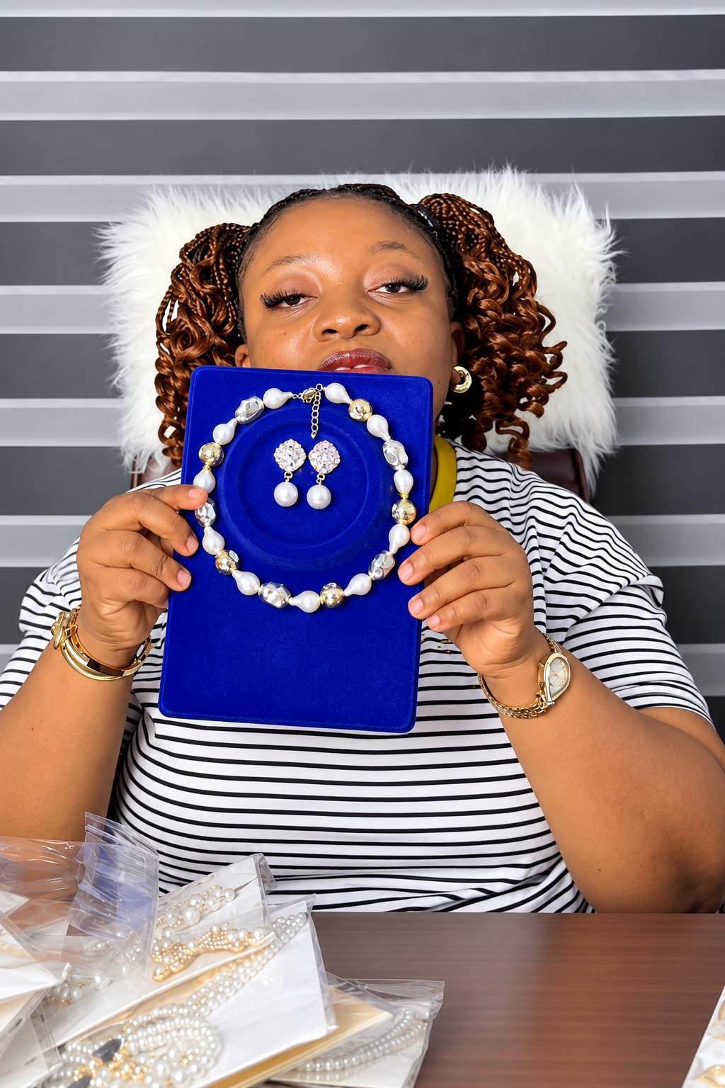 Amara showing a pearl necklace and earrings from Shakara